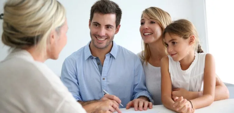 Happy couple at home representing family protection through life interest Wills.